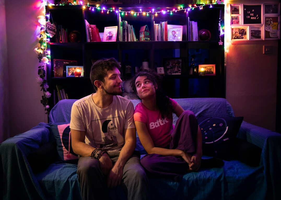 Family watching television together in a living room in the evening